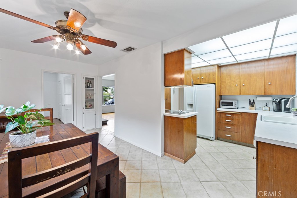 4425 Walnut Avenue Long Beach, CA 90807 - Photo 18 of 50 a kitchen with stainless steel appliances kitchen island granite countertop a sink a stove and a refrigerator