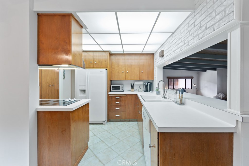 4425 Walnut Avenue Long Beach, CA 90807 - Photo 19 of 50 a kitchen with a sink a refrigerator and window