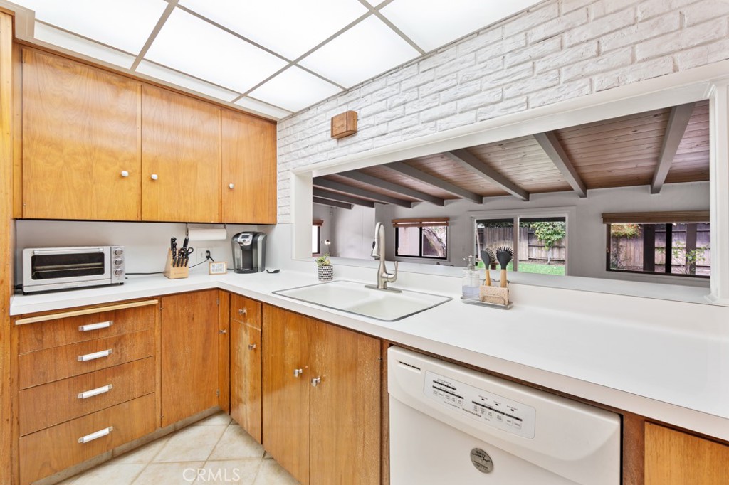 4425 Walnut Avenue Long Beach, CA 90807 - Photo 21 of 50 a kitchen with stainless steel appliances sink and cabinets