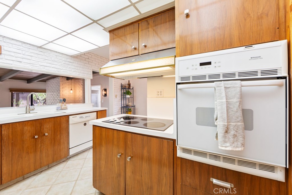 4425 Walnut Avenue Long Beach, CA 90807 - Photo 23 of 50 a kitchen with stainless steel appliances granite countertop a sink and a refrigerator
