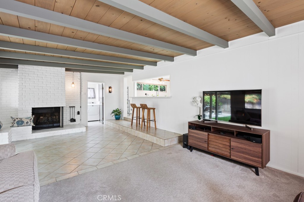 4425 Walnut Avenue Long Beach, CA 90807 - Photo 31 of 50 a living room with furniture a flat screen tv and a fireplace