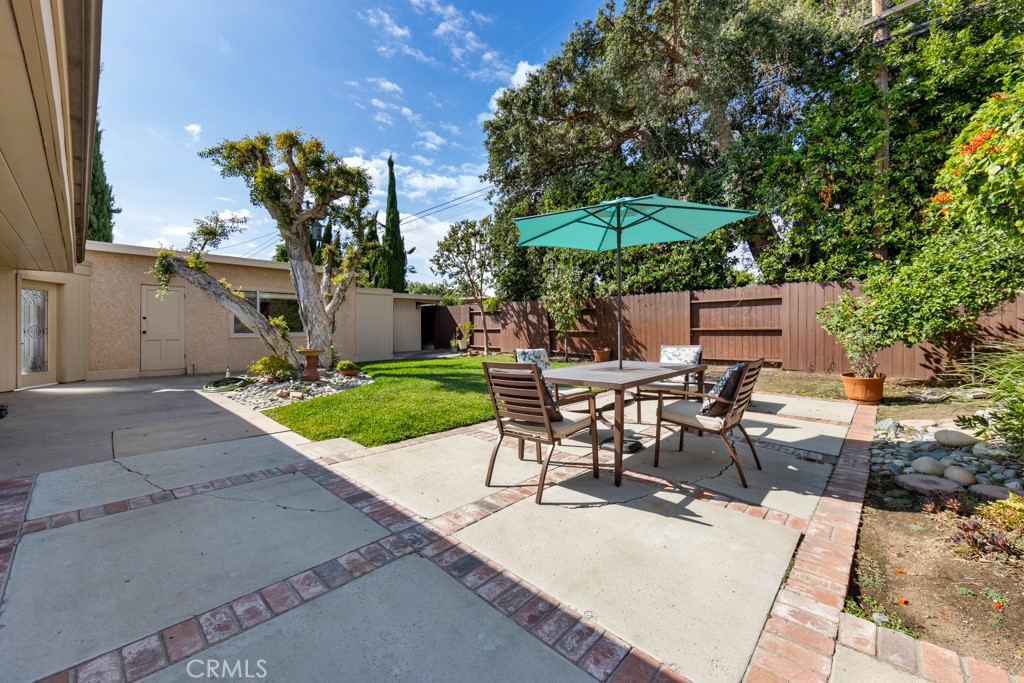4425 Walnut Avenue Long Beach, CA 90807 - Photo 43 of 50 a view of a backyard with table and chairs under an umbrella