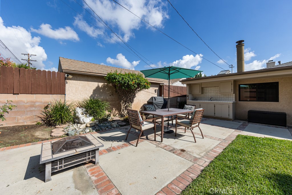 4425 Walnut Avenue Long Beach, CA 90807 - Photo 46 of 50 a view of a patio with table and chairs potted plants with wooden floor
