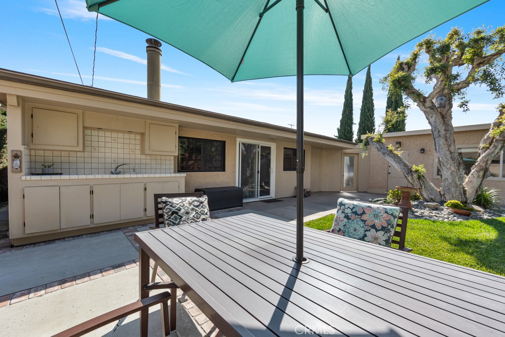 4425 Walnut Avenue Long Beach, CA 90807 - Photo 49 of 50 a view of a patio with table and chairs under an umbrella