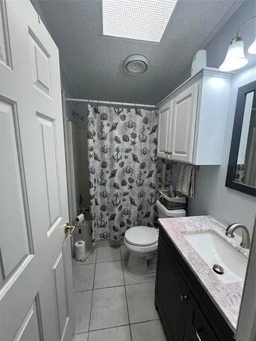 a bedroom with a bed a mirror and lamp