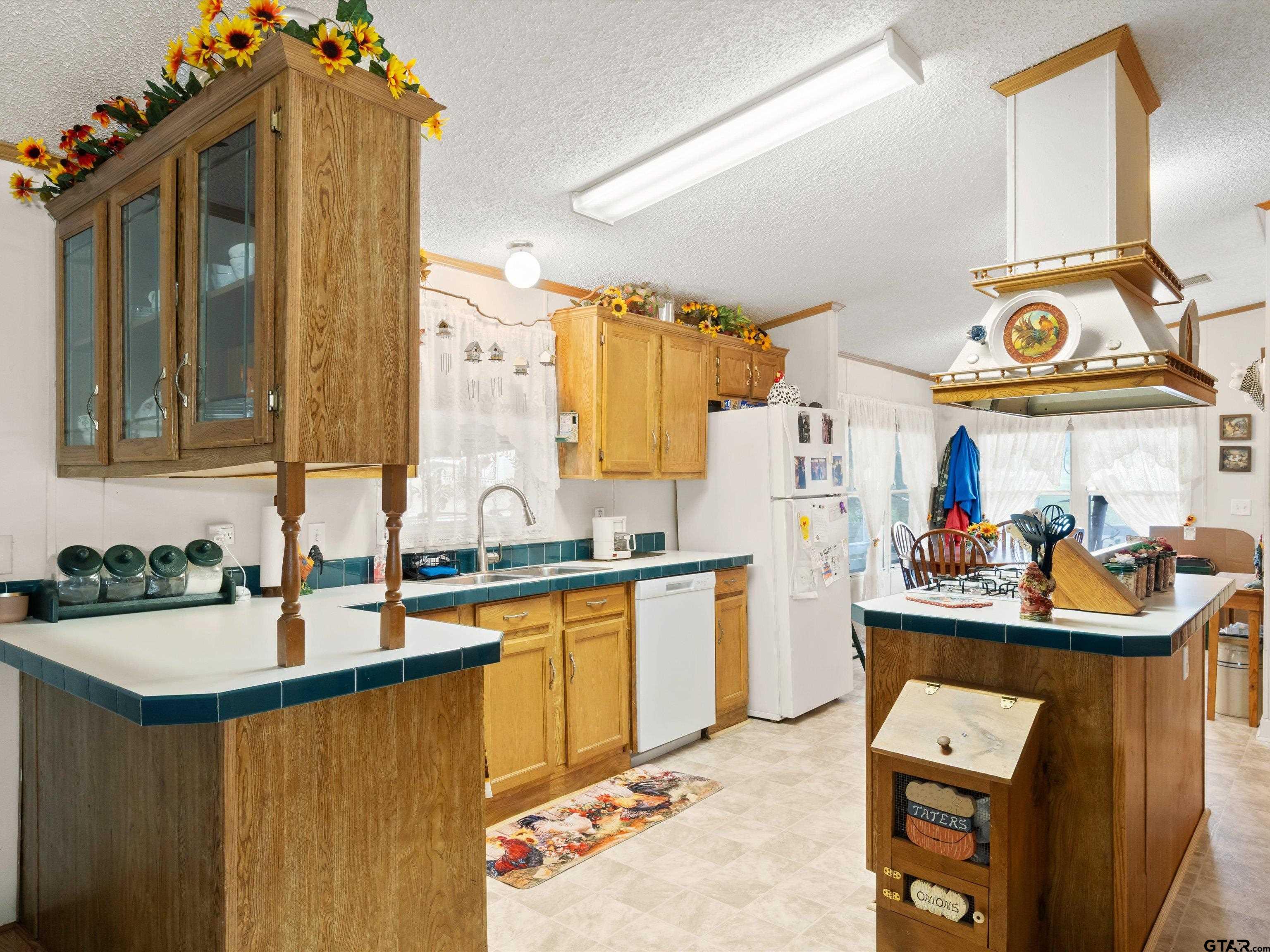 2811 Medlin Road Gilmer, TX 75645 - Photo 15 of 30 a kitchen with stainless steel appliances a sink and a wooden floor