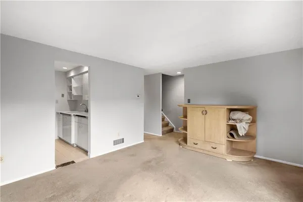 a kitchen with stainless steel appliances a sink stove and cabinets