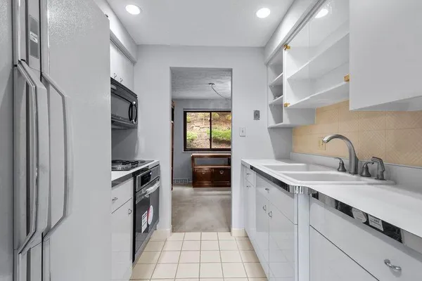 a kitchen with a stove a refrigerator and a sink