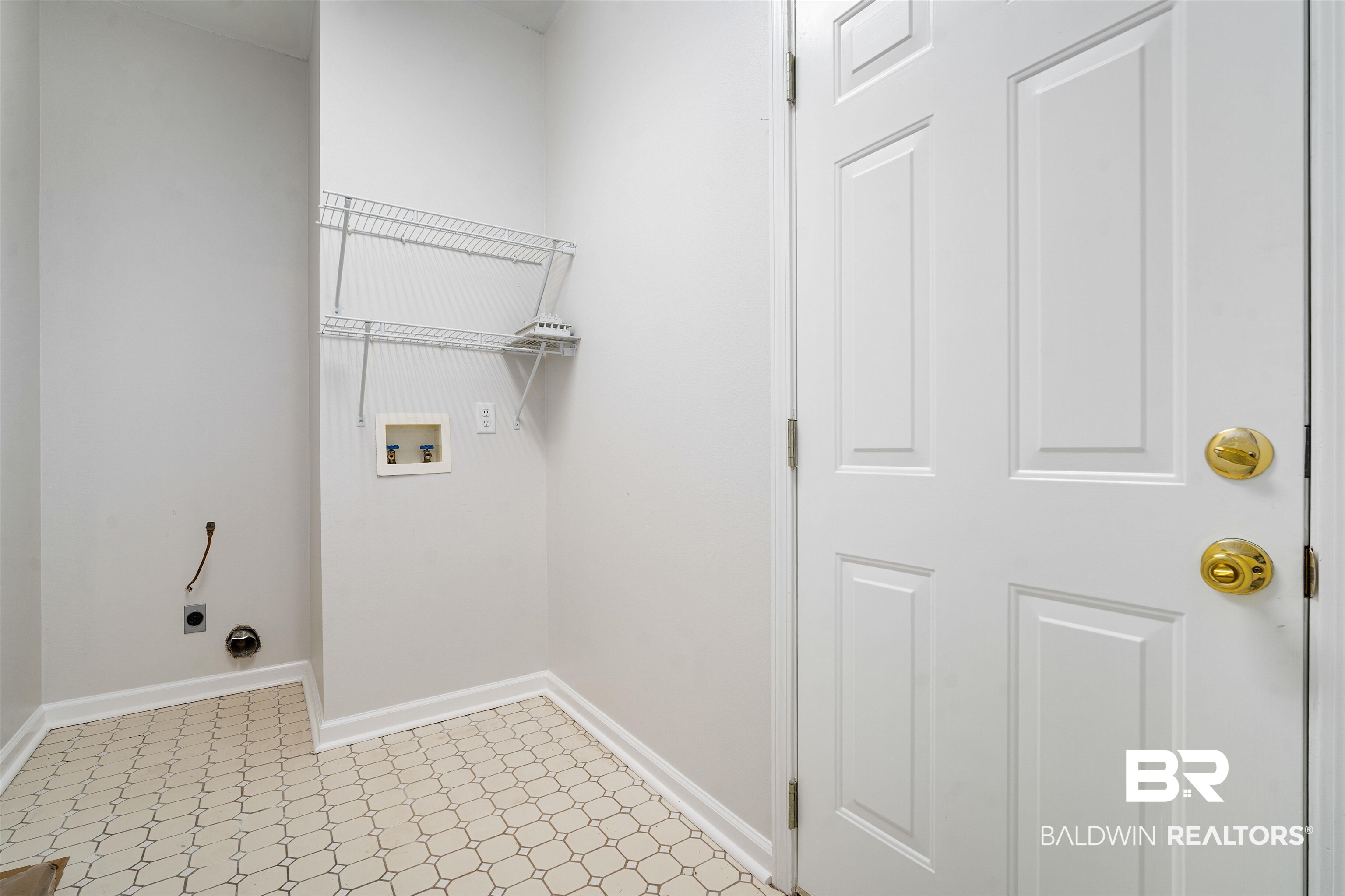250 North Spring Lake Drive Mobile, AL 36695 - Photo 24 of 29 Laundry area featuring light flooring, hookup for a washing machine, and hookup for an electric dryer. Plus door to single car garage.