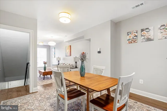 a dining room with furniture and wooden floor