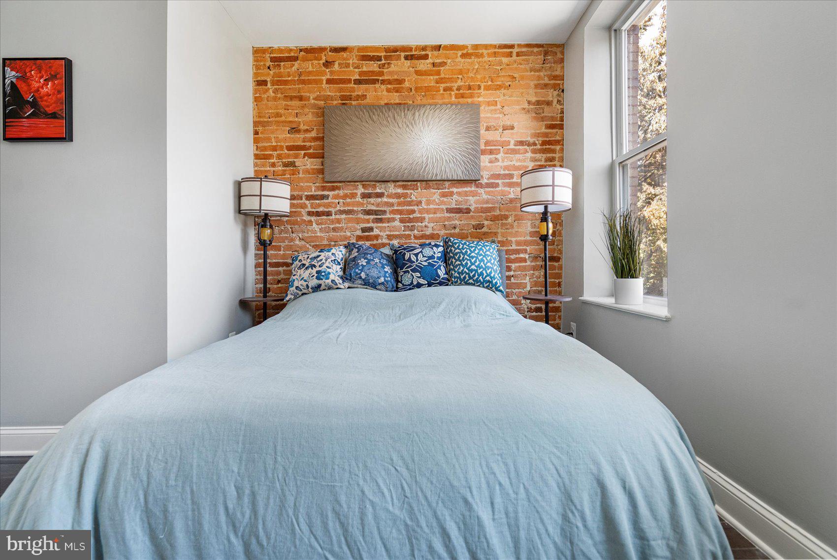 2428 McCulloh Street Baltimore, MD 21217 - Photo 16 of 42 a bedroom with a bed and a flat screen tv