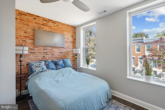 a bed sitting in a bedroom next to a window