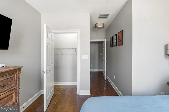 a view of hallway with wooden floor and staircase
