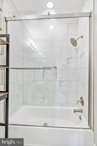 a bathroom with a shower and a bath tub