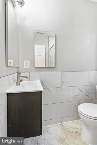 a bathroom with a sink toilet and mirror