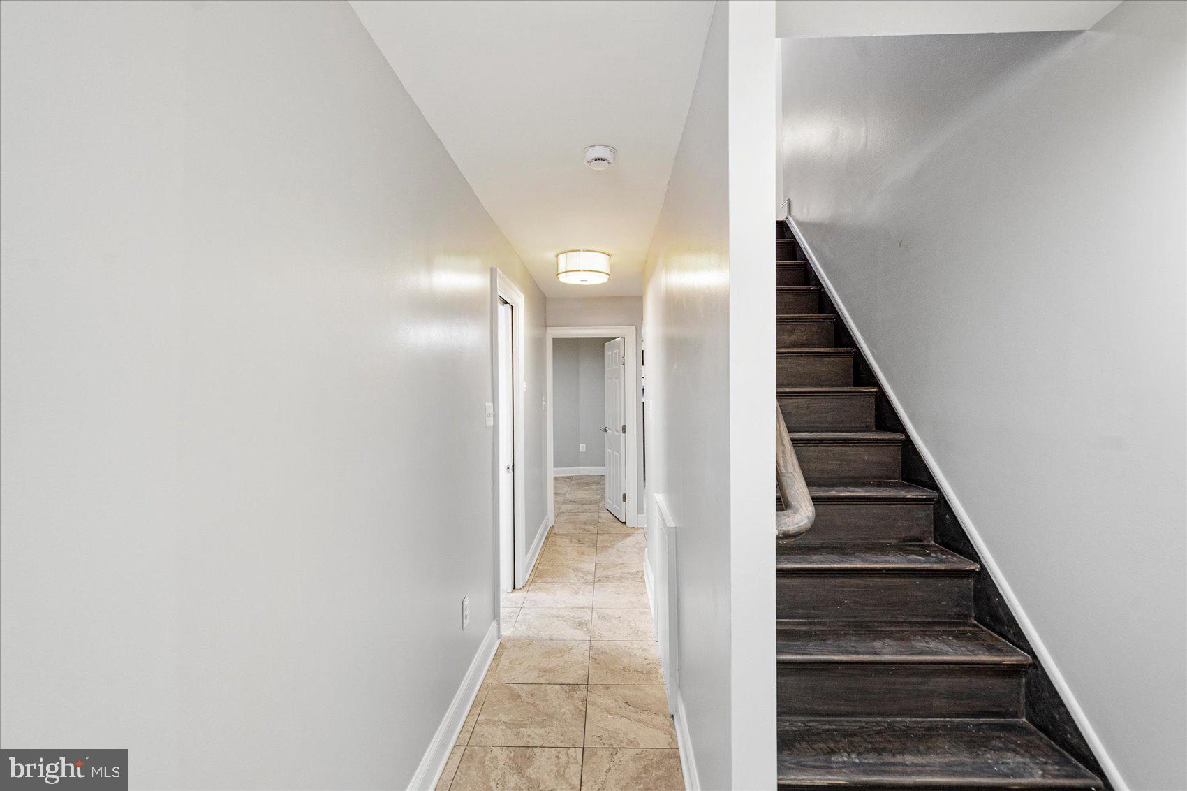 2428 McCulloh Street Baltimore, MD 21217 - Photo 30 of 42 a view of a hallway with wooden floor and stairs