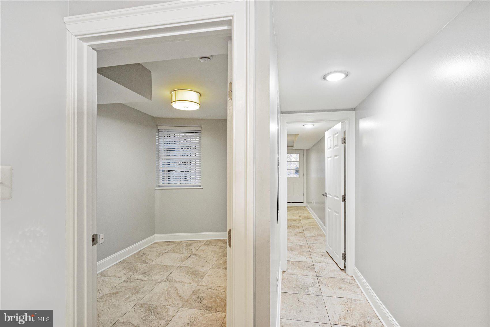 2428 McCulloh Street Baltimore, MD 21217 - Photo 36 of 42 a view of a hallway with wooden floor and a bathroom