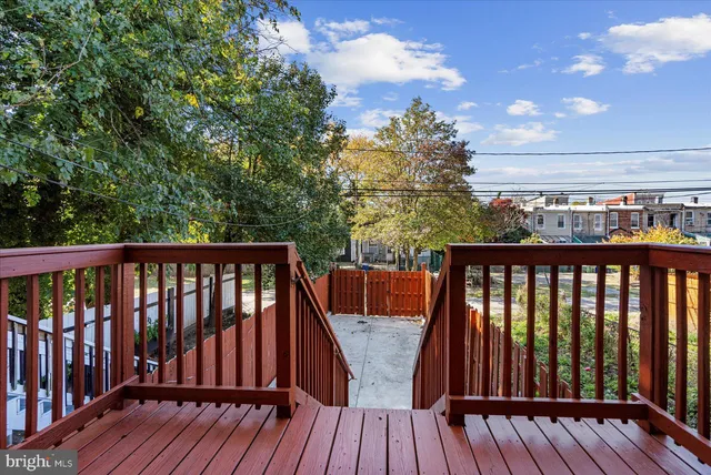 a view of balcony with wooden floor and outdoor seating