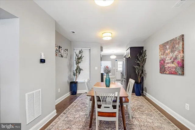 a dining room with furniture and wooden floor
