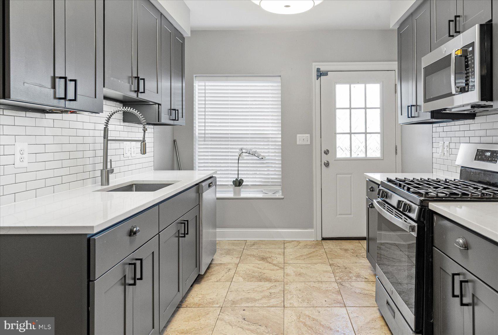 2428 McCulloh Street Baltimore, MD 21217 - Photo 9 of 42 a kitchen with stainless steel appliances granite countertop a sink stove and refrigerator