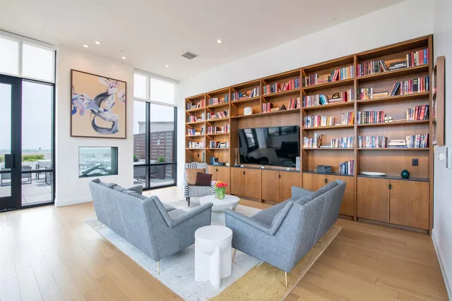 a living room with furniture and potted plants