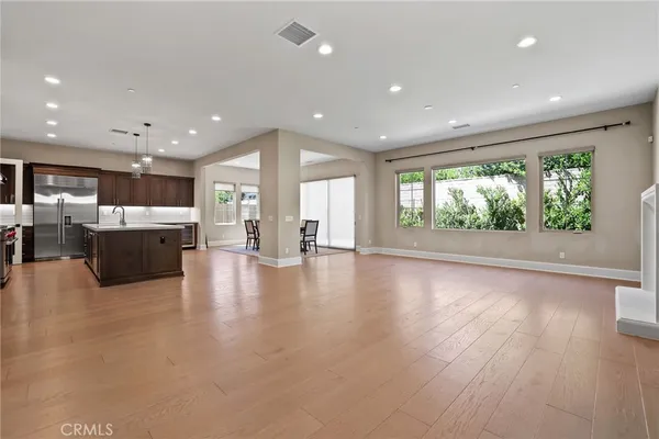 a view of a livingroom with furniture wooden floor and windows