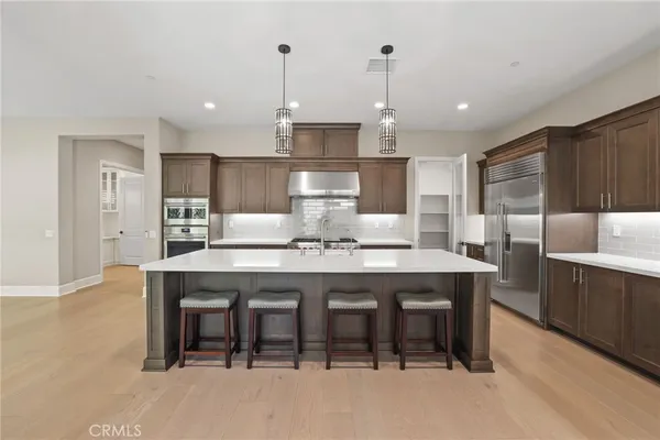 a large kitchen with a table and chairs