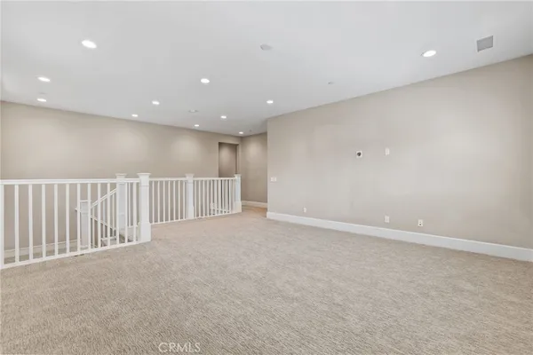 an empty room with large windows