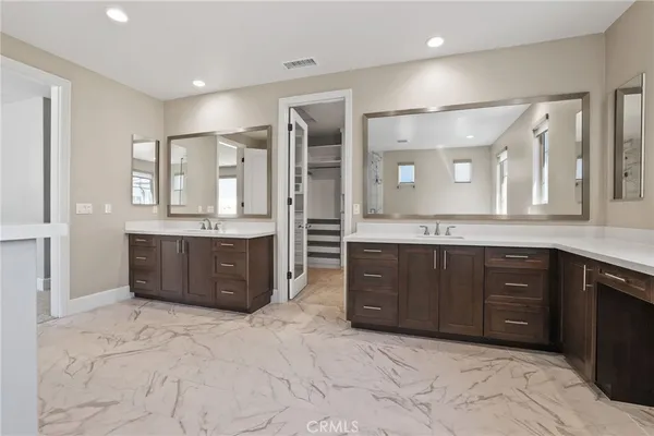 a large bathroom with a large tub sink and double vanity