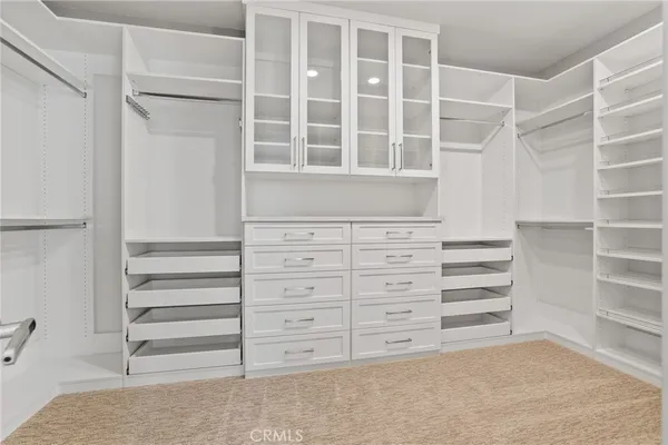 a view of walk in closet with empty racks