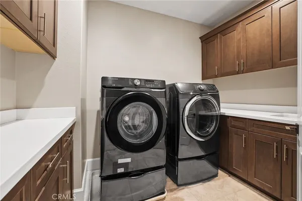 a view of a storage and utility room with washer and dryer