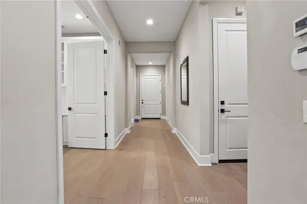 a view of a hallway with wooden floor