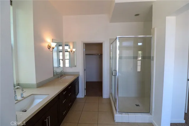 a bathroom with a double vanity sink and a mirror