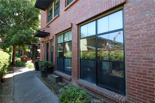 a view of a brick house with a large windows