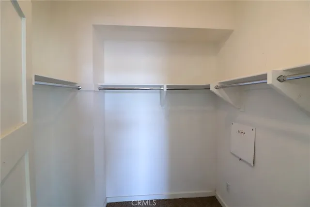 a view of a room with shelf on the wall