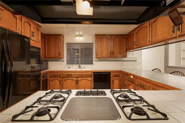 a kitchen with a sink stove and refrigerator