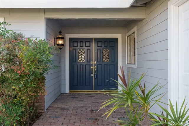 a view of front door and potted plants