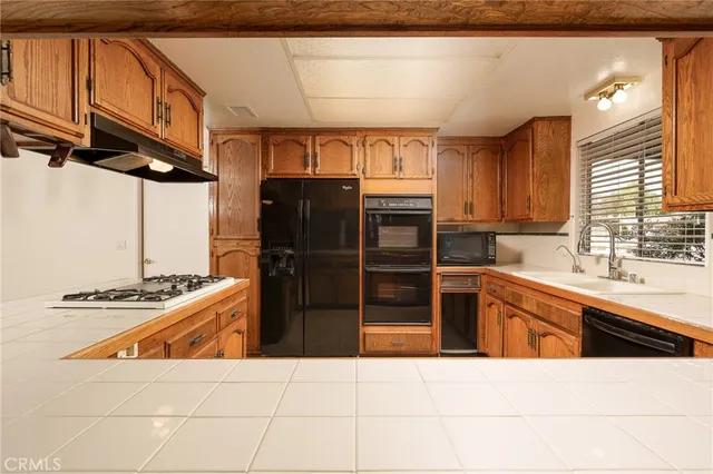 a kitchen with stainless steel appliances kitchen island granite countertop a sink and cabinets