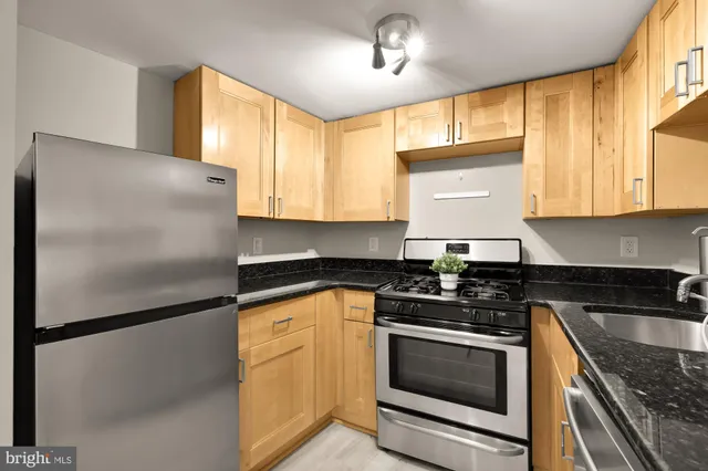 a kitchen with a refrigerator sink and cabinets