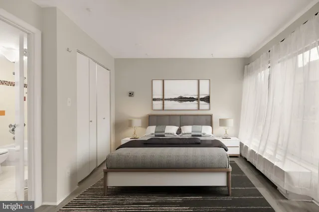 a bedroom with a bed and a window