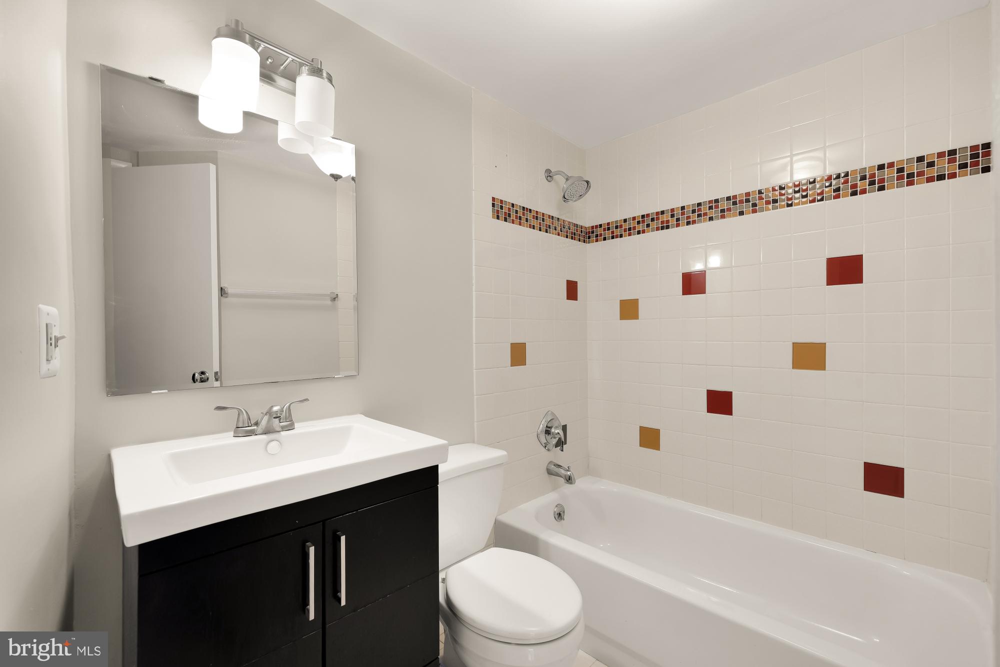 1239 Vermont Avenue Northwest, Unit 102 Washington, DC 20005 - Photo 13 of 21 a bathroom with a sink a toilet and a bathtub