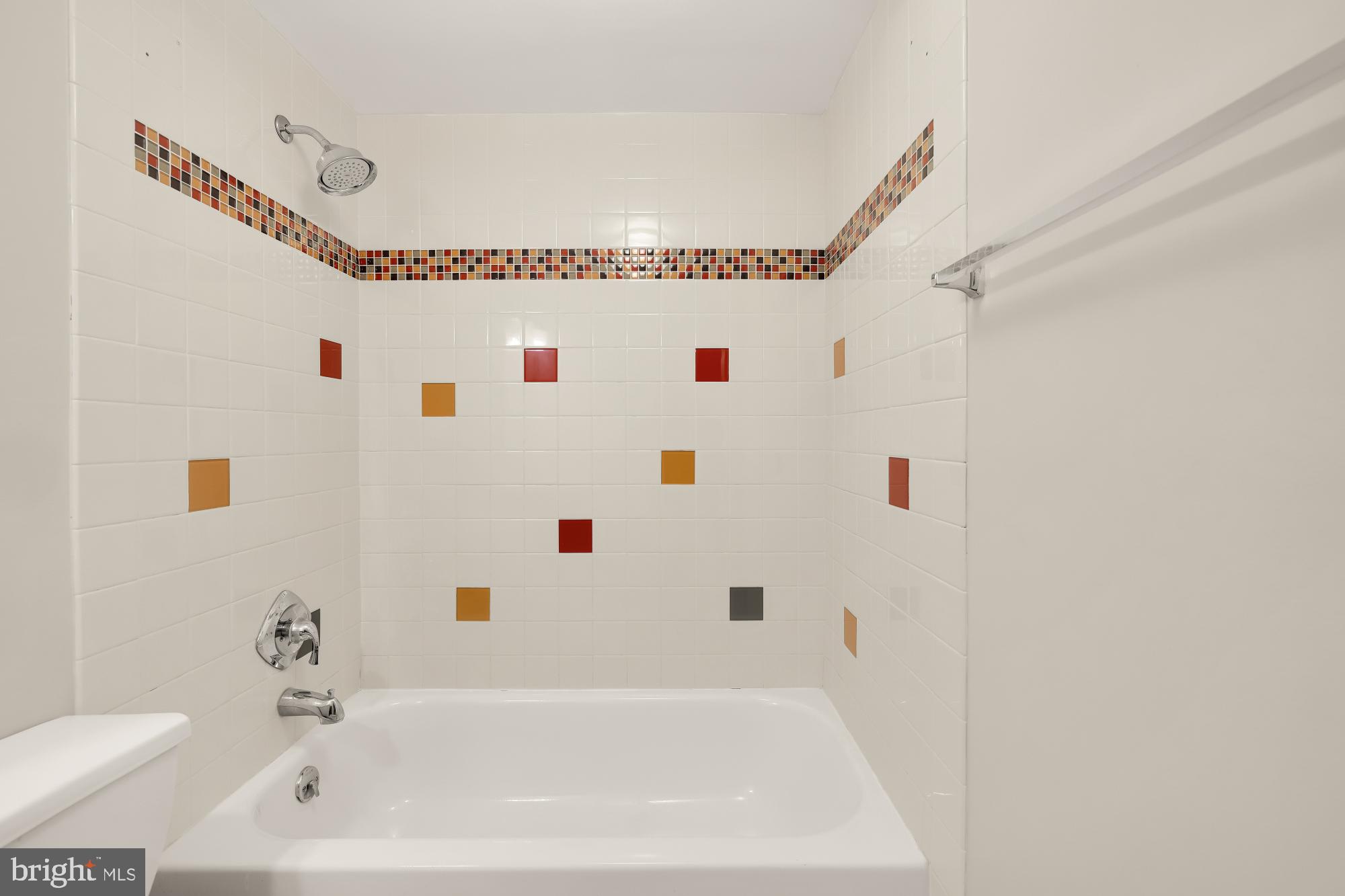 1239 Vermont Avenue Northwest, Unit 102 Washington, DC 20005 - Photo 14 of 21 a bathroom with a white tub shower sink and a sink