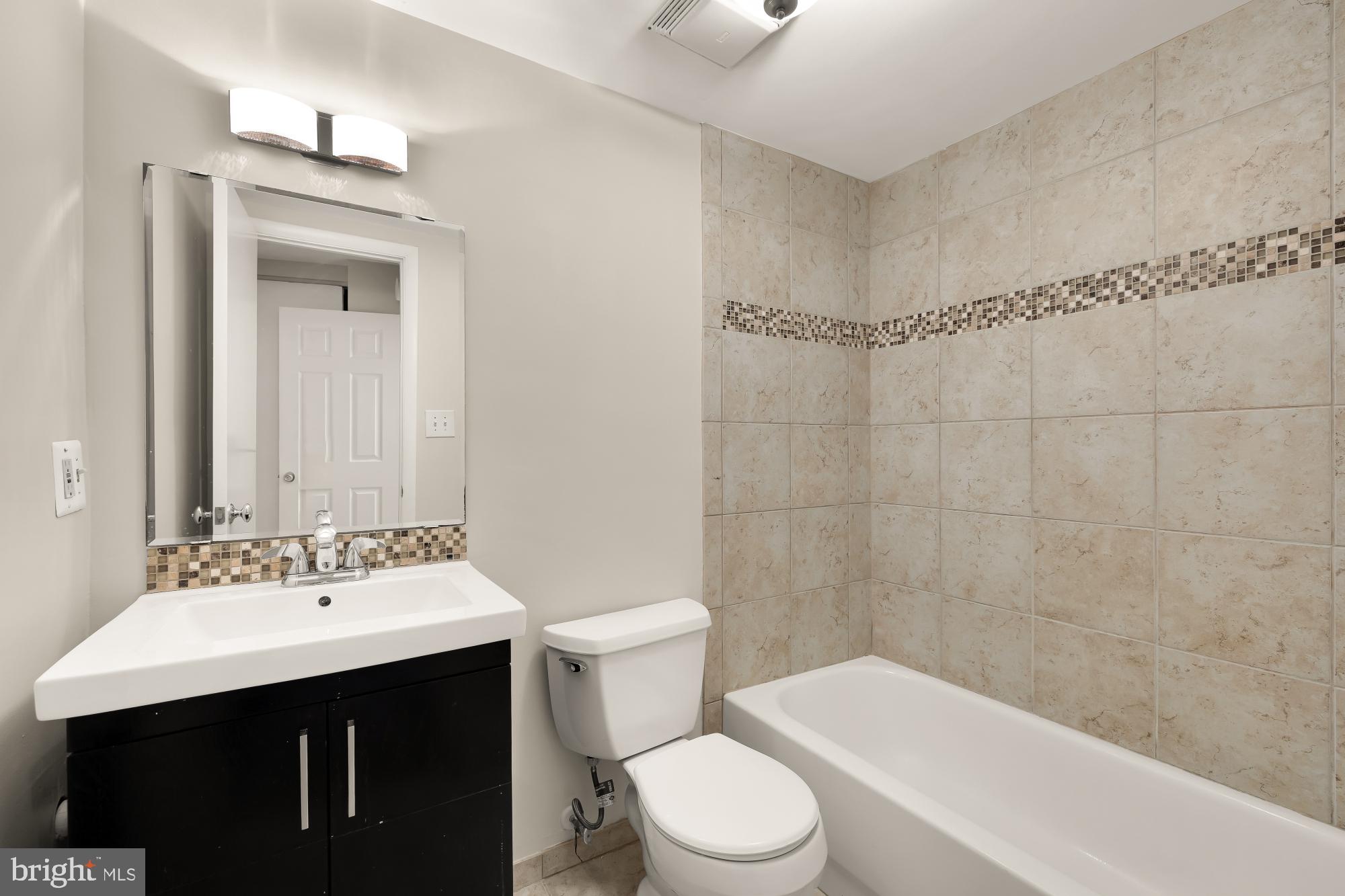 1239 Vermont Avenue Northwest, Unit 102 Washington, DC 20005 - Photo 16 of 21 a bathroom with a sink a toilet and shower