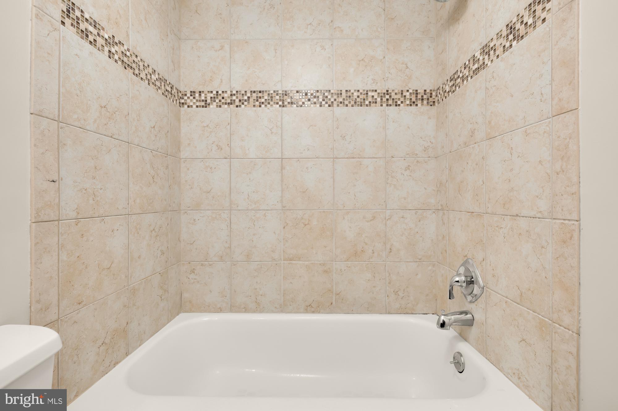 1239 Vermont Avenue Northwest, Unit 102 Washington, DC 20005 - Photo 17 of 21 a bathroom with a bathtub and a toilet