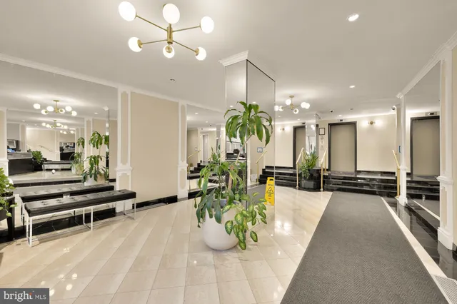 a view of a lobby with furniture and a chandelier