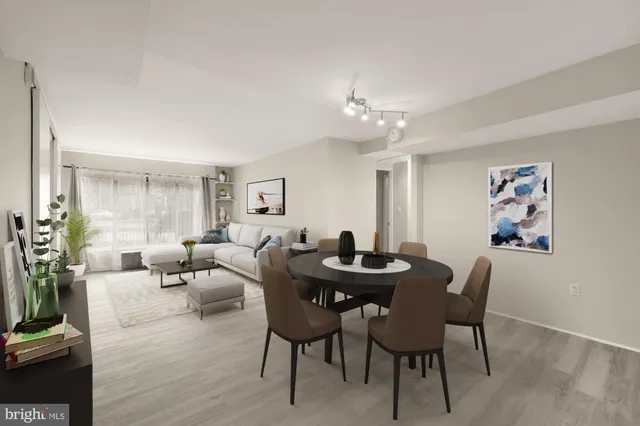 a living room with furniture a table and a potted plant