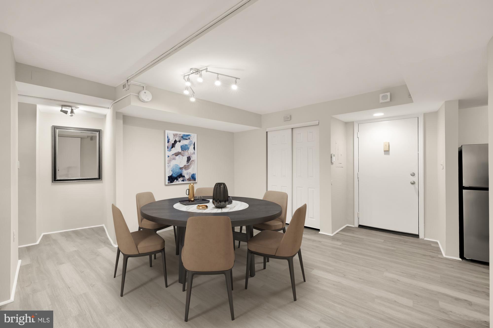 1239 Vermont Avenue Northwest, Unit 102 Washington, DC 20005 - Photo 7 of 21 a view of a dining room with furniture and wooden floor