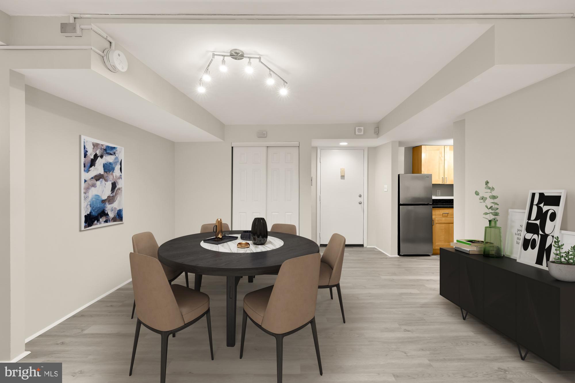 1239 Vermont Avenue Northwest, Unit 102 Washington, DC 20005 - Photo 8 of 21 a view of a dining room with furniture and wooden floor