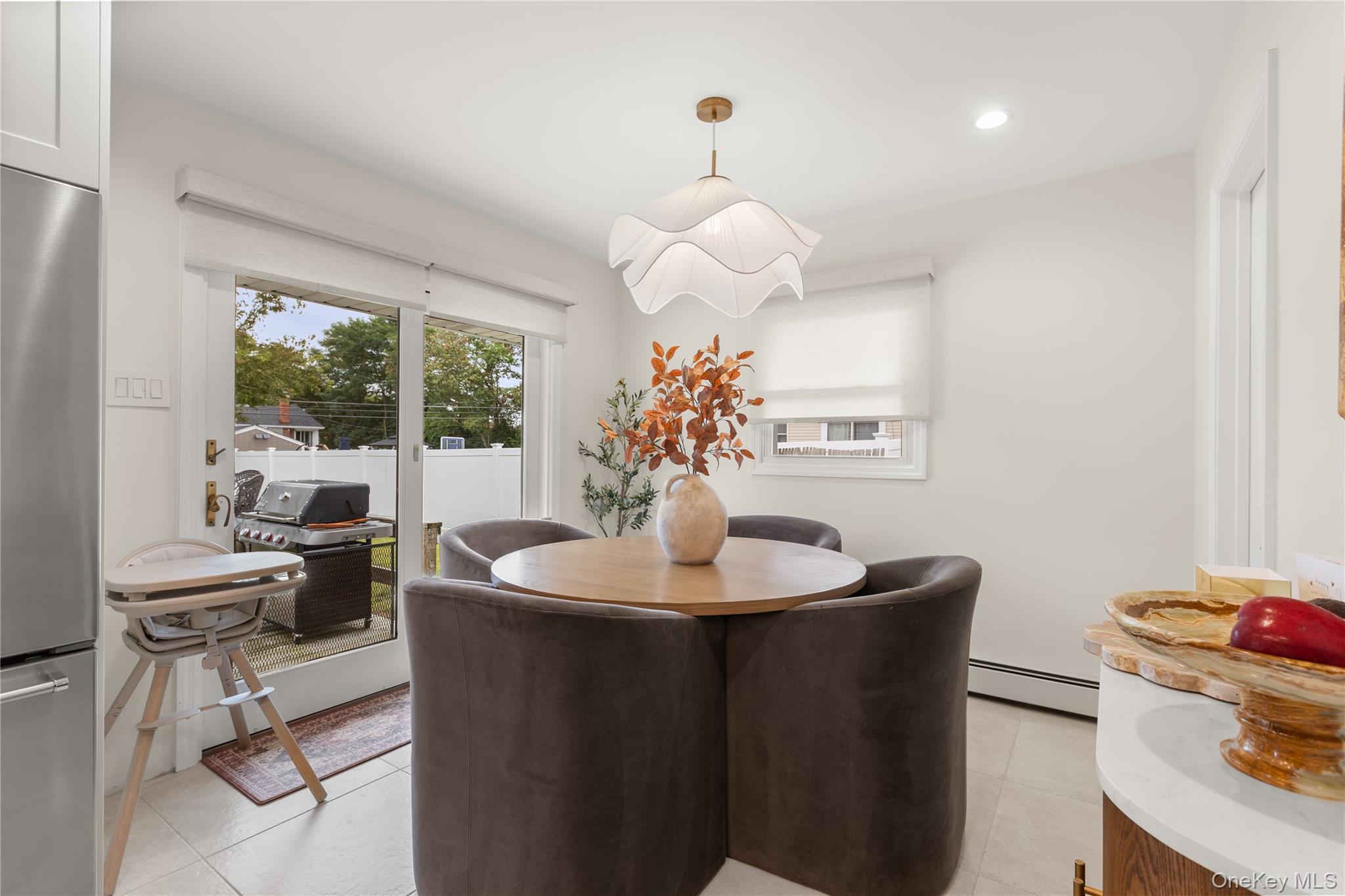 205 Timber Point Road East Islip, NY 11730 - Photo 5 of 16 Dining room featuring light tile patterned floors, baseboard heating, and recessed lighting