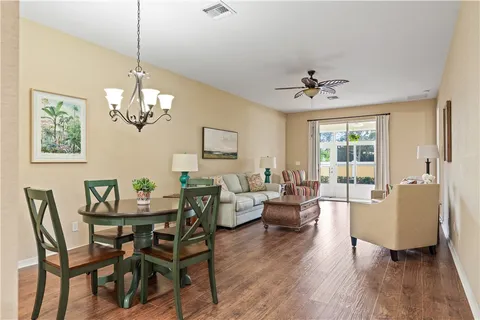 a view of a dining room with furniture wooden floor and chandelier
